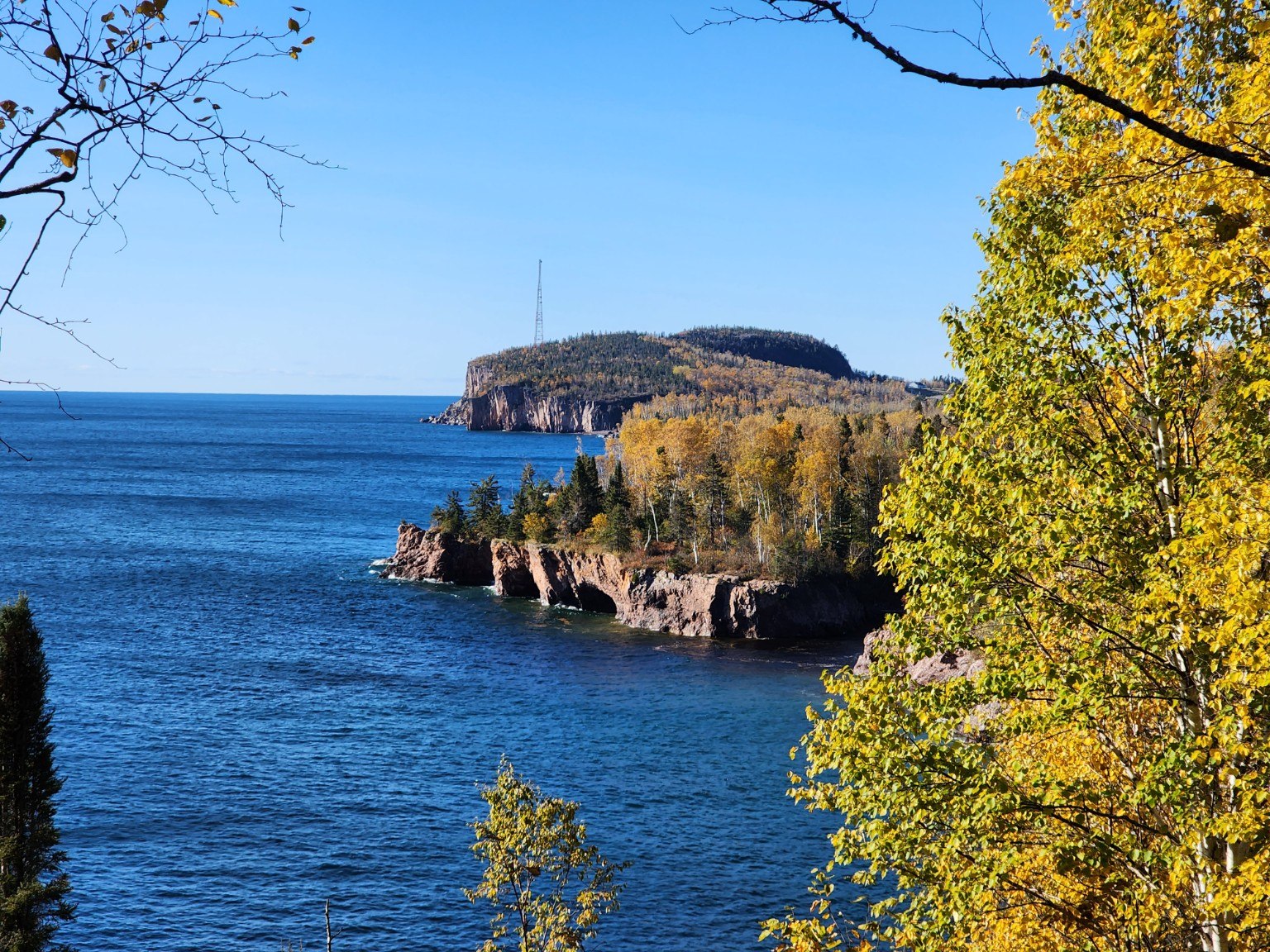 Lake Superior shoreline framed by golden autumn trees