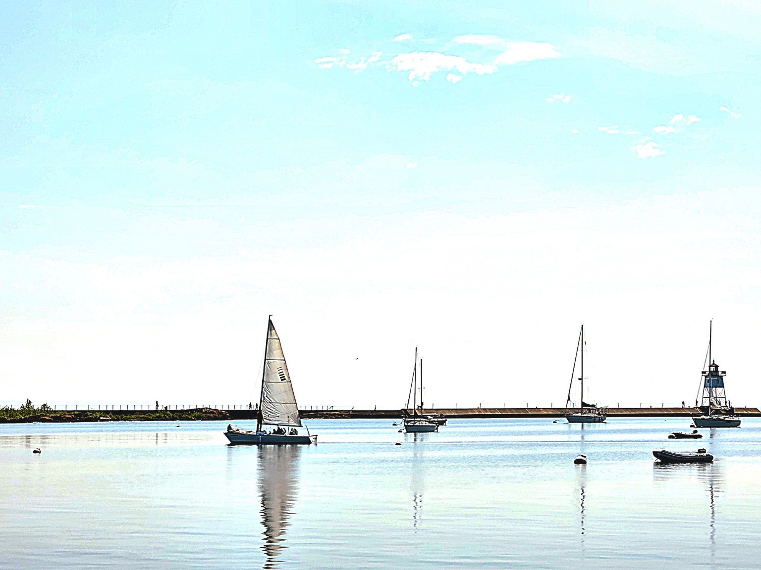 Sailboat and lighthouse in a calm Lake Superior harbor
